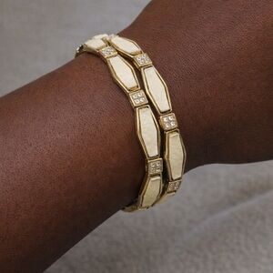 GOLD TONE CREAM ENAMEL BRACLETE WITH CHRYSTAL ACCENTS. EUC